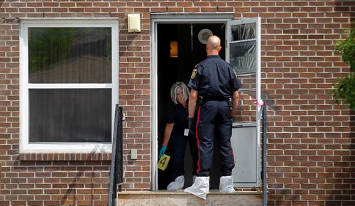 PHIL HOSSACK / WINNIPEG FREE PRESS  -  Police investigators work the scene of a shooting/homicide at 101-740 Selkirk Ave Saturday morning. See Melissa Martin's story.   -  July 22, 2017