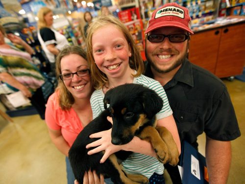 PHIL HOSSACK / WINNIPEG FREE PRESS  -  9 yr old Sara-Lynn Giesbrecht beams while holding her new pup Saturday afternoon. Sara Lynn and her parents Lindsay and Joseph adopted the pup at an adoption event being co-hosted by the Winnipeg Humane Society with one of their satellite adoption centres - Petsmart Kenaston. See story.  -  July 22, 2017