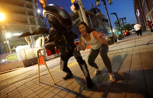 TREVOR HAGAN / WINNIPEG FREE PRESS
Troy Fontaine, dressed as Alien, posing with Jenn Niblett, outside Bell MTS Place, Saturday, July 22, 2017. The costume, made entirely out of recycled bits of junk, is hand made and took Fontaine 3 months to complete.