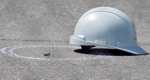 BORIS MINKEVICH / WINNIPEG FREE PRESS
Police shooting scene on Archibald between Messier Street and Kavanagh Street.  A construction helmet near a bullet casing on the road right near the area where a person was shot by police. July 24, 2017