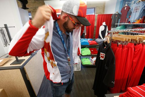 JOHN WOODS / WINNIPEG FREE PRESS
Micheal Reimer tries on some of his favourite Canada Games gear at Canada Games store at the Forks in Winnipeg Monday, July 24, 2017.