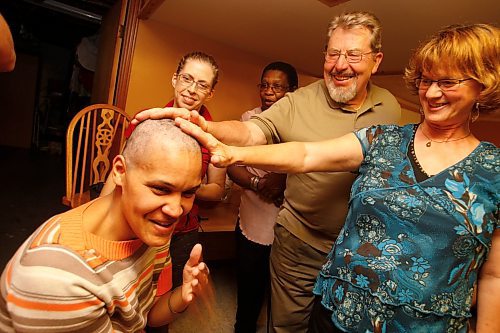 BORIS MINKEVICH / WINNIPEG FREE PRESS  080914 Christina Hazzard lets supporters feel her bald head after getting 105 braids clipped off in the name of Cancer Care. She planned on raising $10 a braid= $1050. SEE EMAIL FOR MORE DETAILS.