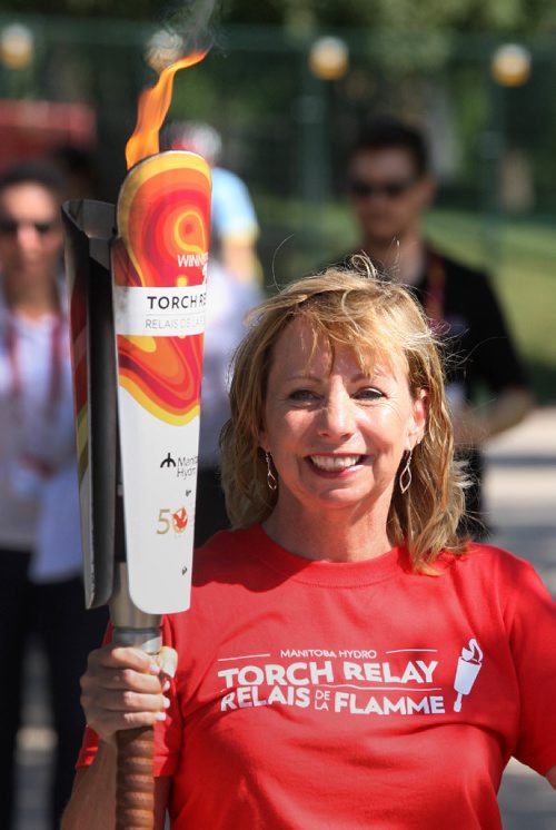 JOE BRYKSA / WINNIPEG FREE PRESS Mavis  Morissette runs Canada Games torch relay at the Forks Wednesday.-  July 26 , 2017 -( See story)