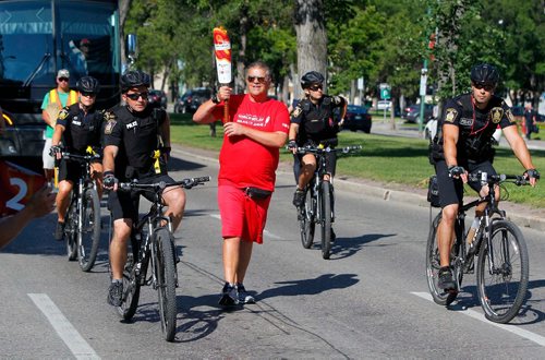 BORIS MINKEVICH / WINNIPEG FREE PRESS
2017 Canada Games torch relay photos. Torchbearer 'Dancing Gabe' Langlois on the first leg of the event on Broadway and Kennedy. July 26, 2017