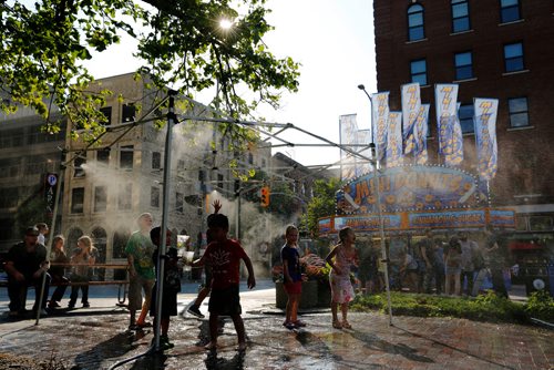 JUSTIN SAMANSKI-LANGILLE / WINNIPEG FREE PRESS
Kids run around and cool off in a mist tent Wednesday at Old Market Square during Fringe Fest.
170726 - Wednesday, July 26, 2017.