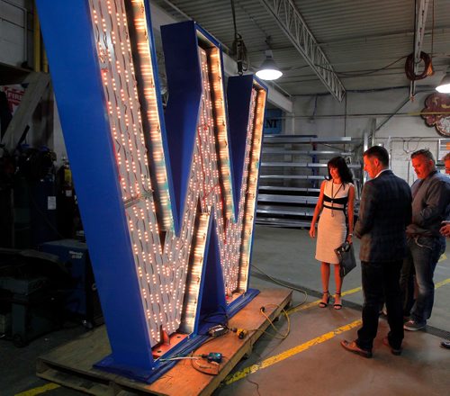 BORIS MINKEVICH / WINNIPEG FREE PRESS
From left, Dayna Spiring, President and CEO of Economic Development Winnipeg, Mayor Brian Bowman, and Shane Storie, President of SRS Signs. Dayna Spiring, and Mayor Bowman dropped by SRS Signs to get a close up look at the 'W' in the Winnipeg sign that is being installed at The Forks. The W is eight feet tall and seven feet wide.  July 27, 2017