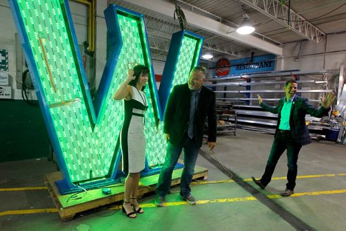 BORIS MINKEVICH / WINNIPEG FREE PRESS
From left, Dayna Spiring, President and CEO of Economic Development Winnipeg, Shane Storie, President of SRS Signs, and Mayor Brian Bowman. Dayna Spiring, and Mayor Bowman dropped by SRS Signs to get a close up look at the 'W' in the Winnipeg sign that is being installed at The Forks. In this photo Spiring and Bowman react to the sign cycling to the color green saying they don't want to support the Sask. Riders football colours. The W is eight feet tall and seven feet wide.  July 27, 2017