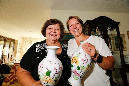 JUSTIN SAMANSKI-LANGILLE / WINNIPEG FREE PRESS
Liz Kovach and her daughter, Liz Jr. pose with a pair of traditional Hungarian Hollohaza porcelain vases Thursday. Kovach and her family have been an integral part of the Hungary-Pannonia pavilion at Folklorama for decades. 
170727 - Thursday, July 27, 2017.