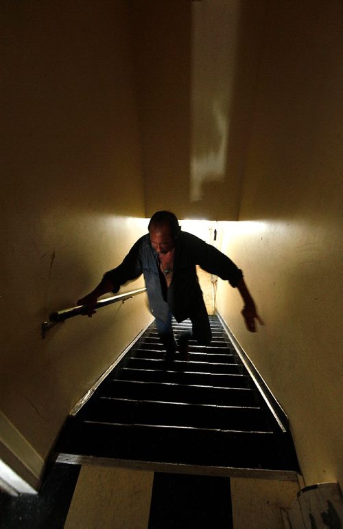 PHIL HOSSACK / WINNIPEG FREE PRESS  -   Mark Witt braces himself ascending the stairway to his 2 room "suite"  at a North End rooming house. See Mike McIntylre's story.   -  July 27, 2017
