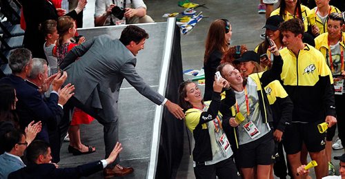 PHIL HOSSACK / WINNIPEG FREE PRESS  -  Prime Minister Justin Trudeau and a pair of Manitoba athletes grab selfies as the teams marched into the Canada Games Opening Ceremonies at the Bell MTS Place Friday evening.  -  July 28, 2017