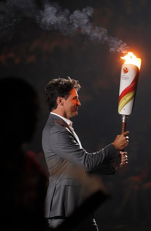 PHIL HOSSACK / WINNIPEG FREE PRESS  -  Prime Minister Justin Trudeau carries the Games Flame towards the Cauldron at the Canada Games Opening Ceremonies at the Bell MTS Place Friday evening.  -  July 28, 2017