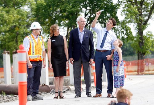 PHIL HOSSACK / WINNIPEG FREE PRESS  -  Left to Right, Mike Peters of Bird Construction, Margaret Redmond and Hartley Richardson of the Assiniboine  Park Conservancywatch as  PM Justin Trudeau and his daughter Ella-Grace check out a building material sample on a tour of the future site of Canada's Diversity Gardens Saturday Morning.  -  July 29, 2017