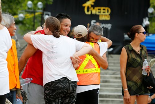 JUSTIN SAMANSKI-LANGILLE / WINNIPEG FREE PRESS
Members of a memorial group embrace Saturday after walking into the Forks Oodena Circle during the 9th annual No Stone Unturned benefit concert for Manitoba's murdered and missing. 
170729 - Saturday, July 29, 2017.