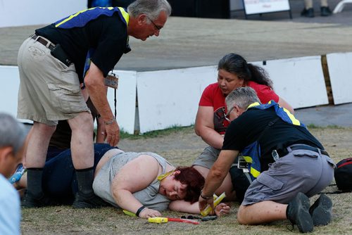 JOHN WOODS / WINNIPEG FREE PRESS
A woman collapses due to heat at the Fringe main stage Sunday, July 30, 2017.
