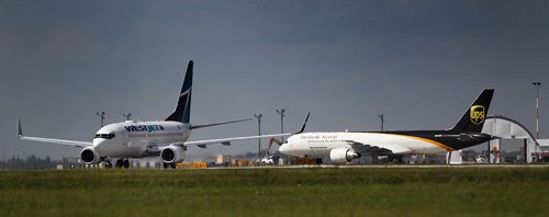 PHIL HOSSACK / WINNIPEG FREE PRESS  -   A WestJet Boeing 737 taxis past a UPS Boeing 75 at Richardson International Airport Monday afternoon. See Murray McNeil's story.  -  July 31, 2017