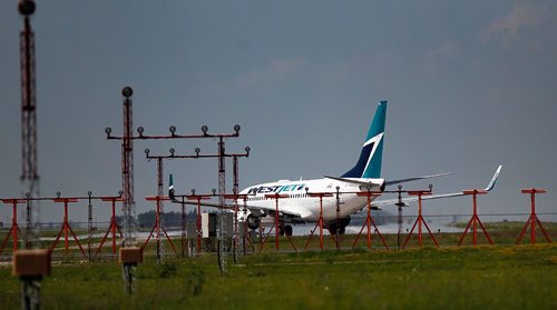 PHIL HOSSACK / WINNIPEG FREE PRESS  -   A WestJet Boeing lines up on the runway for take off at Richardson International Airport Monday afternoon. See Murray McNeil's story.  -  July 31, 2017