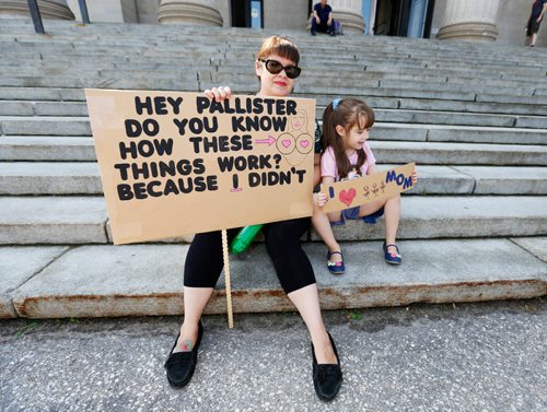 JUSTIN SAMANSKI-LANGILLE / WINNIPEG FREE PRESS
Julie Mungall and her daughter Islay hold up signs in front of the legislature building protesting Manitoba Government cuts to the Health Sciences Centre's Women's Hospital Lactation Consultant program.
170801 - Tuesday, August 01, 2017.