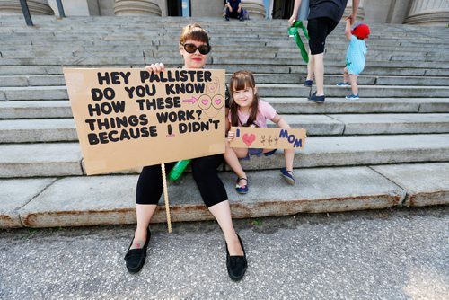 JUSTIN SAMANSKI-LANGILLE / WINNIPEG FREE PRESS
Julie Mungall and her daughter Islay hold up signs in front of the legislature building protesting Manitoba Government cuts to the Health Sciences Centre's Women's Hospital Lactation Consultant program.
170801 - Tuesday, August 01, 2017.