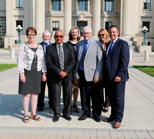 JUSTIN SAMANSKI-LANGILLE / WINNIPEG FREE PRESS
From left: Indigenous and Municipal Relations Minister Eileen Clarke, Stephen Masson, President, Manitoba Saskatchewan Prospectors and Developers Association, Chief Ron Evans of Norway House Cree Nation, Andrea McLandress, Executive Director, Mining Association of Manitoba, Jim Downey, former Manitoba Premiere and cabinet minister, Ruth Bezys, President, Manitoba Prospectors and Developers Association and Growth, Enterprise ad Trade Minister Cliff Cullen pose outside the Manitoba Legislature Building Tuesday.
170801 - Tuesday, August 01, 2017.