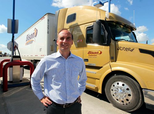 BORIS MINKEVICH / WINNIPEG FREE PRESS
BISON TRUCKING - VP Finance & CFO Damiano Coniglio poses in front of a tractor trailer on their lot on Sherwin Road. August 1, 2017