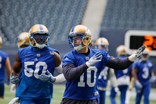 JUSTIN SAMANSKI-LANGILLE / WINNIPEG FREE PRESS
Bombers line backer Sam Hurl talks about a play with his teammates in between drills during Wednesday's practice at Investor's Group Field. 
170802 - Wednesday, August 02, 2017.
