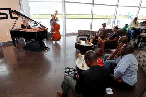 BORIS MINKEVICH / WINNIPEG FREE PRESS
Photo of a jazz duo (singer and pianist Helen White and her accompanist on bass) entertaining passing passengers just beyond the security screening set up. 
The WAA started this unique musical gift to the flying public and the staff recently and have had good feedback. Helen White plays piano and sings and Larry Bjornson plays the upright bass. August 4, 2017