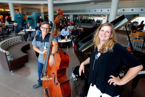BORIS MINKEVICH / WINNIPEG FREE PRESS
Photo of a jazz duo (singer and pianist Helen White and her accompanist on bass) entertaining passing passengers just beyond the security screening set up. 
The WAA started this unique musical gift to the flying public and the staff recently and have had good feedback. Helen White plays piano and sings and Larry Bjornson plays the upright bass. August 4, 2017