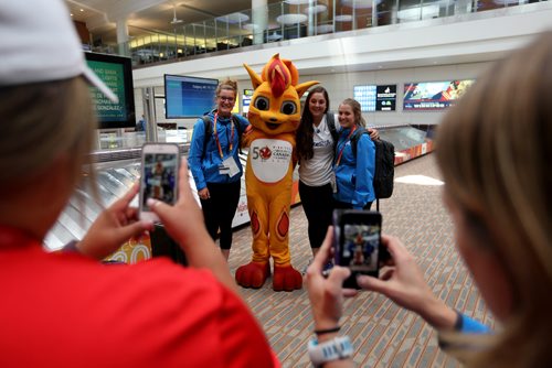TREVOR HAGAN / WINNIPEG FREE PRESS
Team Alberta softball players, Natalie Bender, Becki Monaghan, and Taylor Campbell, posing with Niibin, the games mascot as they arrive at the airport to begin week two of the Canada Summer Games, Saturday, August, 5, 2017.