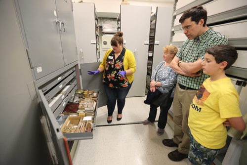 TREVOR HAGAN / WINNIPEG FREE PRESS
Cortney Pachet explains a drawer full of artifacts to Micheline Cournoyer, Gerald Heckman, and Paul Heckman, 11, during a tour through archives at the Manitoba Museum, Friday, August, 4, 2017.