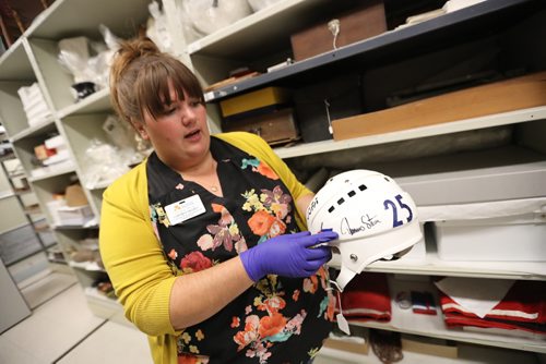 TREVOR HAGAN / WINNIPEG FREE PRESS
Cortney Pachet shows a helmet that belonged to former Winnipeg Jets' Thomas Steen and pants worn by goaltender Tim Cheveldae during a tour through archives at the Manitoba Museum, Friday, August, 4, 2017.
