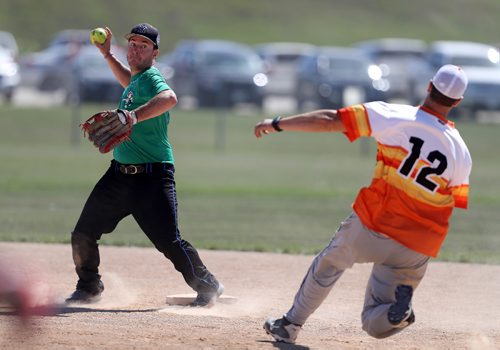 TREVOR HAGAN / WINNIPEG FREE PRESS
Garrett Pawluk, of the Pitch Slappers, from Abbotsford, BC, tries to turn a double play as Conrad Funk, of the Prides Thunder from Swift Current, Saskatchewan, tries to run to second base during Slow Pitch Nationals at Little Mountain Sportsplex, Sunday, August 6, 2017.