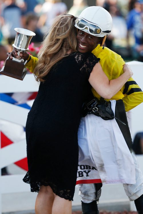 JOHN WOODS / WINNIPEG FREE PRESS
Tyrone Nelson gets a hug after winning the Manitoba Derby on Plentiful (2) at Assiniboia Downs Monday, August 7, 2017.
