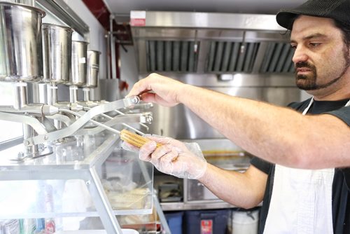 MIKE DEAL / WINNIPEG FREE PRESS

Jacko Garcia makes a churro in his food truck The Churro Stop during a media call promoting the upcoming ManyFest and the Food Truck Wars event which takes place in Memorial Park September 8-10. 

170808
Tuesday, August 08, 2017