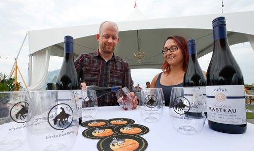 WAYNE GLOWACKI / WINNIPEG FREE PRESS

Interstellar Rodeo Wine curator Ben MacPhee-Sigurdson pours a glass of French red wine beside Kim Bamburak with Kenaston Wine Market who supplies Ortas Tradition Rasteau that is paired with Father John Misty for this years Interstellar Rodeo August 18-20 at The Forks. This wine choice is multi-layered, complex but very open and honest like performer Father John Mist. At this preview event held on the parkade at The Forks Tuesday provided details of this years artist-and-wine pairings and food offerings, which include individual artist pairings, new house wines for 2017 and exclusive Interstellar Rodeo food items offered by select vendors Ben, also the Wine columnist with the Winnipeg Free Press shared some notes at the event on his selection process this year. August 8 2017