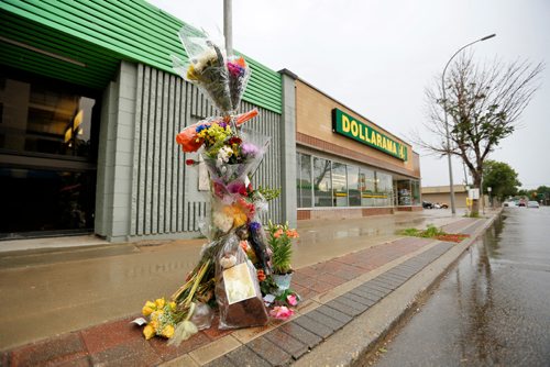 JUSTIN SAMANSKI-LANGILLE / WINNIPEG FREE PRESS
A flower memorial for Marlene Eusanio stands in front of 259 Marion St. Wednesday. Eusanio was killed in a hit and run on August 3. Her family requests that people donate flowers to the memorial in her memory.
170809 - Wednesday, August 09, 2017.