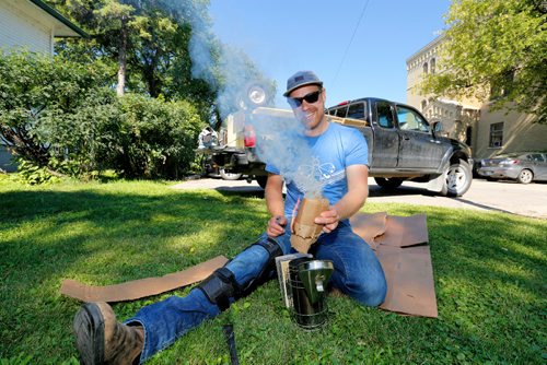 JUSTIN SAMANSKI-LANGILLE / WINNIPEG FREE PRESS
Chris Kirouac prepares a smoker before working on some beehives on the grounds of the Marymound School Thursday. The smoke is used to make the bees hungry enough to retreat into the hives to gorge themselves on honey instead of bothering the beekeepers. 
170810 - Thursday, August 10, 2017.