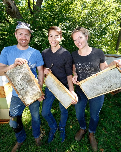 JUSTIN SAMANSKI-LANGILLE / WINNIPEG FREE PRESS
Chris Kirouac, Lucas Smith and Lindsay Nikkel pose with honeycomb racks full of honey Thursday after removing them from their urban hives on the grounds of the Marymound School.
170810 - Thursday, August 10, 2017.