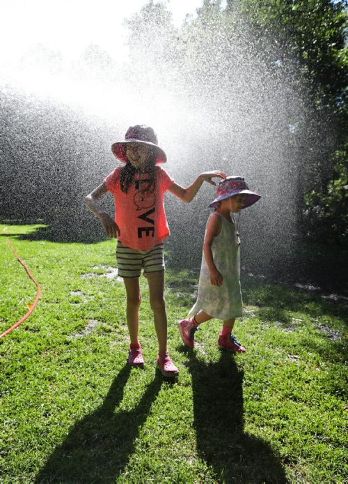 RUTH BONNEVILLE / WINNIPEG FREE PRESS

Four-year-old Esme Kulik and her sister Maelle - 6yrs cool themselves  in a sprinkler at the Leo Mol Sculpture Garden in Assiniboine Park while visiting with their dad and little brother Thursday.   
Standup photo 
  
Aug 10,, 2017