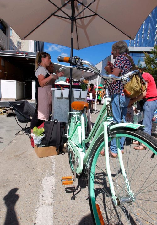 BORIS MINKEVICH / WINNIPEG FREE PRESS
SOFT SPOT ICE CREAM - Amelia Giesbrecht has an old-fashioned bicycle with a refrigerated unit attached that she sells her ice cream out of at the Hydro Building Farmers Market. August 10, 2017