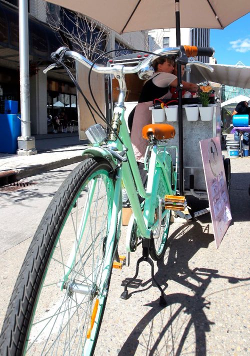 BORIS MINKEVICH / WINNIPEG FREE PRESS
SOFT SPOT ICE CREAM - Amelia Giesbrecht has an old-fashioned bicycle with a refrigerated unit attached that she sells her ice cream out of at the Hydro Building Farmers Market. August 10, 2017