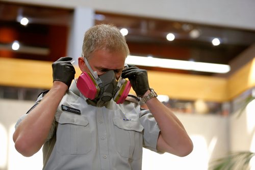 JUSTIN SAMANSKI-LANGILLE / WINNIPEG FREE PRESS
RCMP Sgt. Paul Manaigre demonstrates new Fentanyl protective equipment at an RCMP press conference Friday. The new equipment will be issued to front-line officers. 
170811 - Friday, August 11, 2017.
