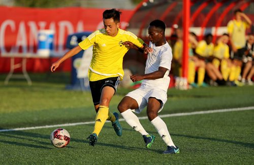 TREVOR HAGAN / WINNIPEG FREE PRESS
Team Manitoba's Damian Truong carries the ball ahead of Team Alberta's Prince Amanda during their soccer match, Friday, August 11, 2017.