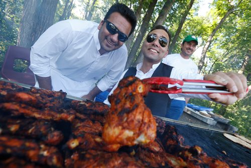 JOHN WOODS / WINNIPEG FREE PRESS
Faisal Khan, Imran and Ali Raza keep an eye on the chicken BBQ at a 70th anniversary celebration of Pakistan independence at St Vital Park Sunday, August 13, 2017.