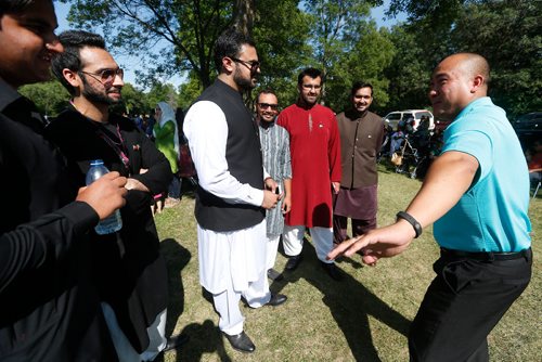 JOHN WOODS / WINNIPEG FREE PRESS
John Reyes, MLA for St Norbert and CFL ball boy, tells some Pakistan partiers a CFL sideline story at a 70th anniversary celebration of Pakistan independence at St Vital Park Sunday, August 13, 2017.