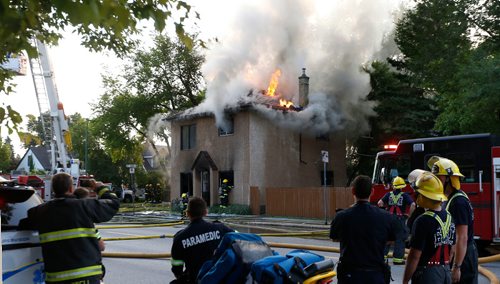 WAYNE GLOWACKI / WINNIPEG FREE PRESS

Winnipeg Fire Fighters and Paramedics on the scene of a house fire at 667 McGregor St.as the aerial ladder is put into position  to pour water on the roof top flames Monday morning. August 14 2017
