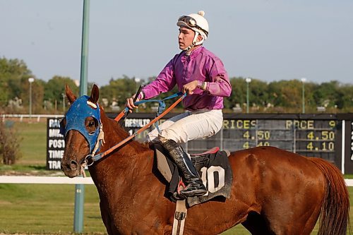 BORIS MINKEVICH / WINNIPEG FREE PRESS  080921 Paul Gray, not in photo, wins $50,000 after horse #10 Rebelmec won the last race of the horse racing season at Assiniboia Downs.