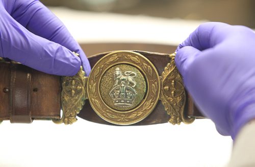 JOE BRYKSA / WINNIPEG FREE PRESS Manitoba Museums Carolyn Sirett, Conservator with  WWII leather uniform belt with copper-alloy buckle. Aug 15, 2017 -( See Melissa Martins 49.8 story  story)