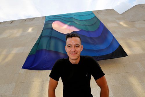 JUSTIN SAMANSKI-LANGILLE / WINNIPEG FREE PRESS
Local artist Kenneth Lavallee poses in front of his Creation Story, which was installed on the side of the Winnipeg Art Gallery Wednesday evening as part of the upcoming INSURGENCE/RESURGENCE exhibition, which opens Sept. 22.
170816 - Wednesday, August 16, 2017.