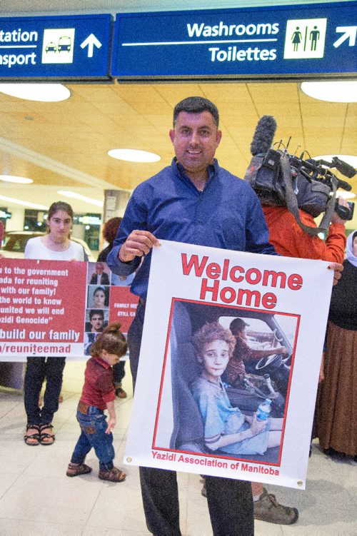 JUSTIN SAMANSKI-LANGILLE / WINNIPEG FREE PRESS
Yazidi Association of Manitoba spokesperson Hadji Hesso holds a sign welcoming 12 year-old Emad Mishko Tamo to Canada early Thursday morning at Winnipeg James Armstrong Richardson International Airport. Tamo was held captive by ISIS and is now re-united with his mother and uncle in Winnipeg.
170817 - Thursday, August 17, 2017.