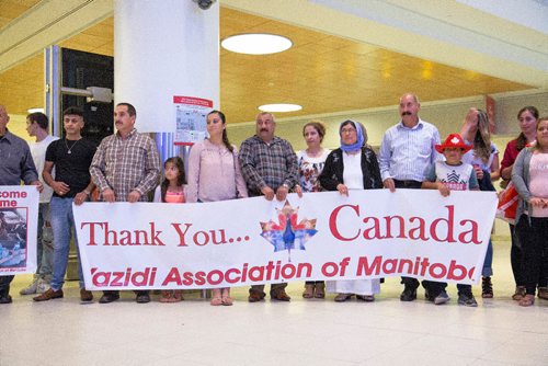 JUSTIN SAMANSKI-LANGILLE / WINNIPEG FREE PRESS
Members of the welcoming party for 12 year-old Emad Mishko Tamo are seen holding a sign early Thursday morning at Winnipeg James Armstrong Richardson International Airport. Tamo was held captive by ISIS and is now re-united with his mother and uncle in Winnipeg.
170817 - Thursday, August 17, 2017.